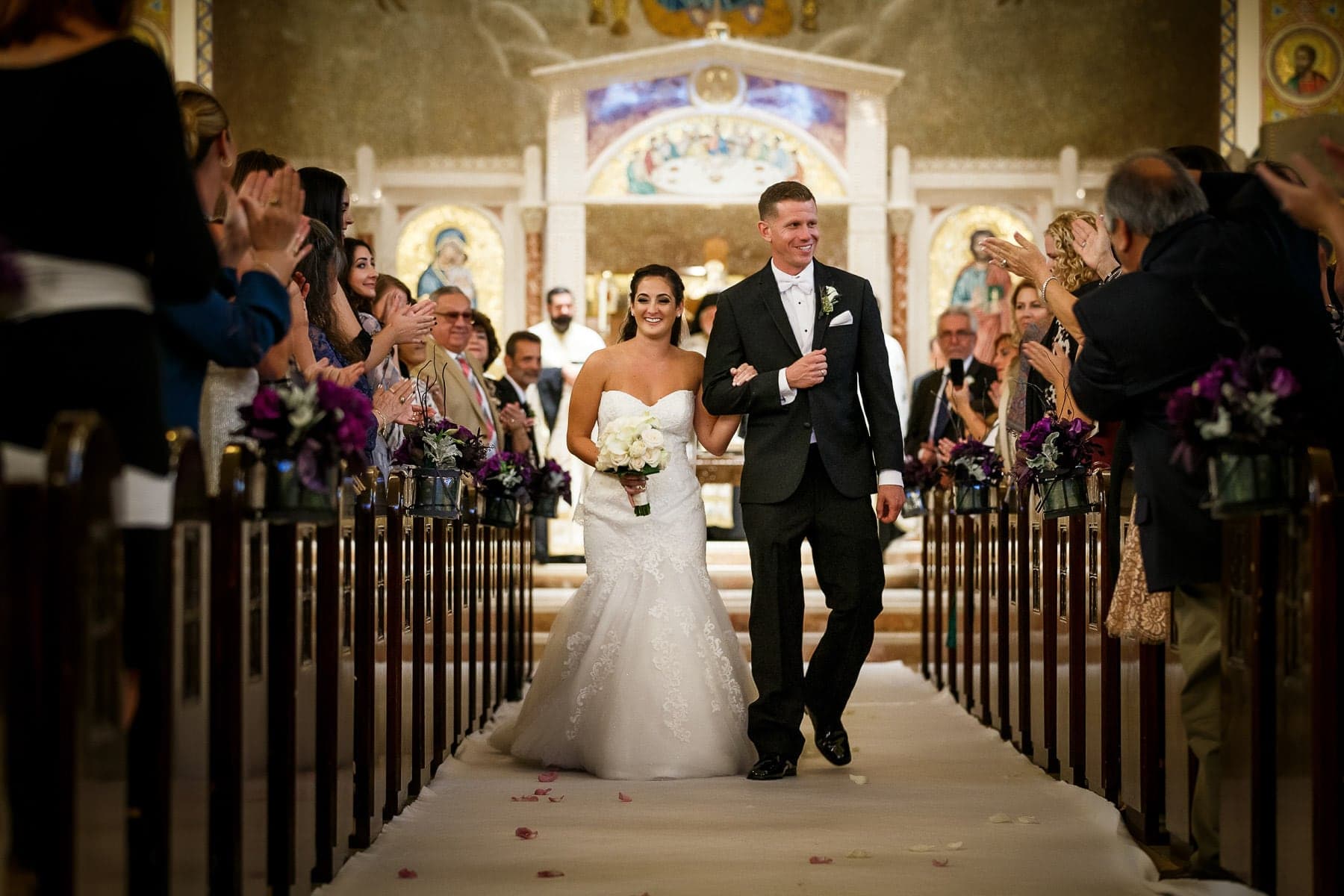 Nikki and Matt walking back up the church aisle