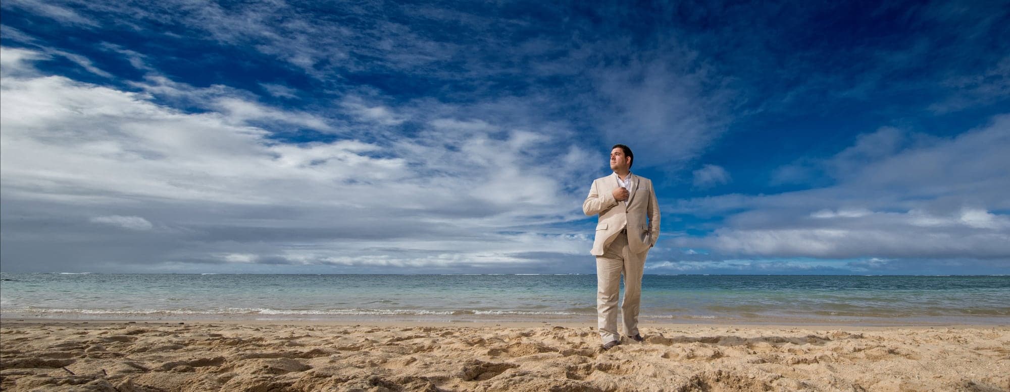 Marco preparing in a light destination wedding suit