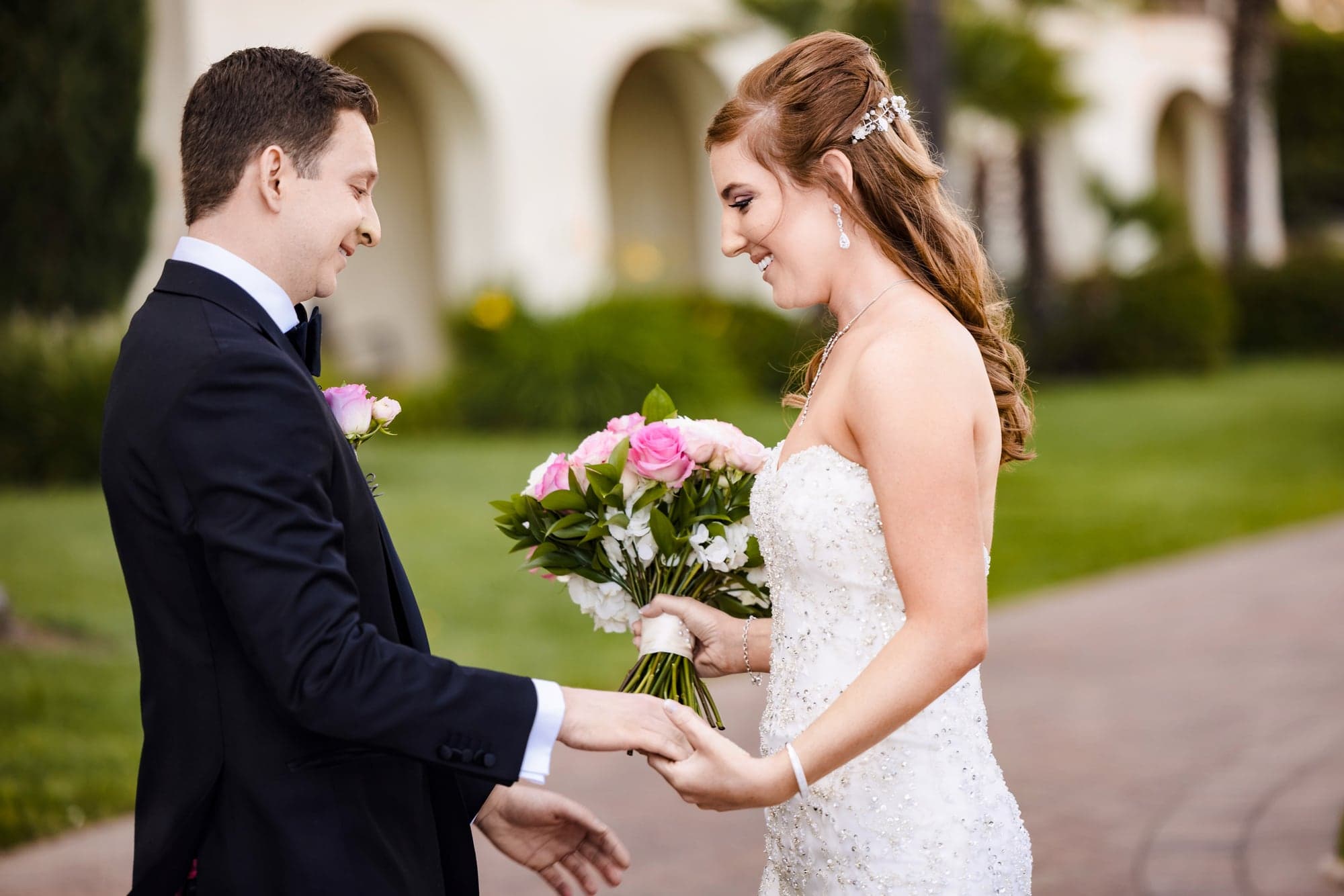 Sarah and Daniel smiling during their garden first look at Terranea Resort
