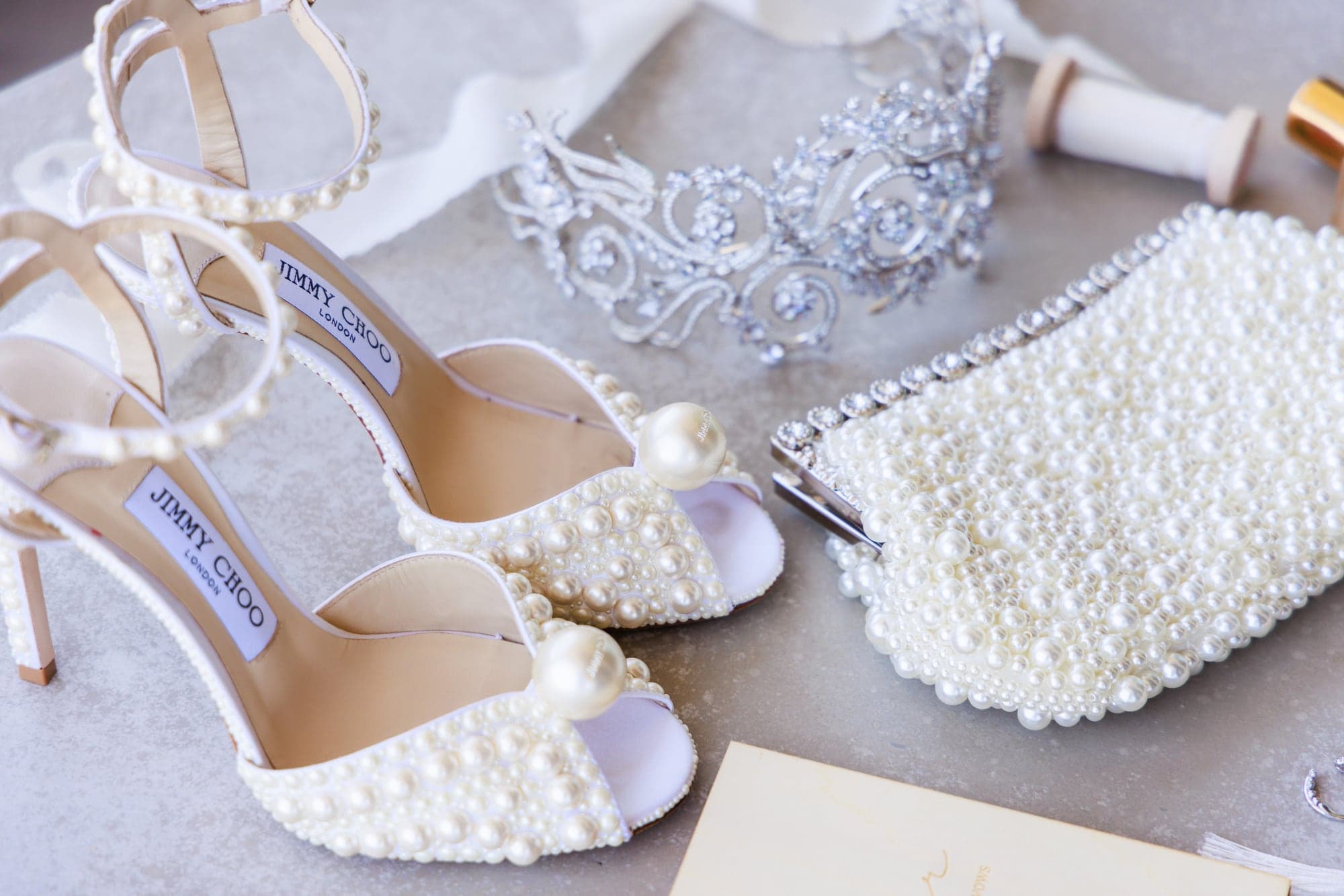 Pearled wedding shoes, jewelry, perfume, and bridal details arranged for Bryanna at The Cape Cabo