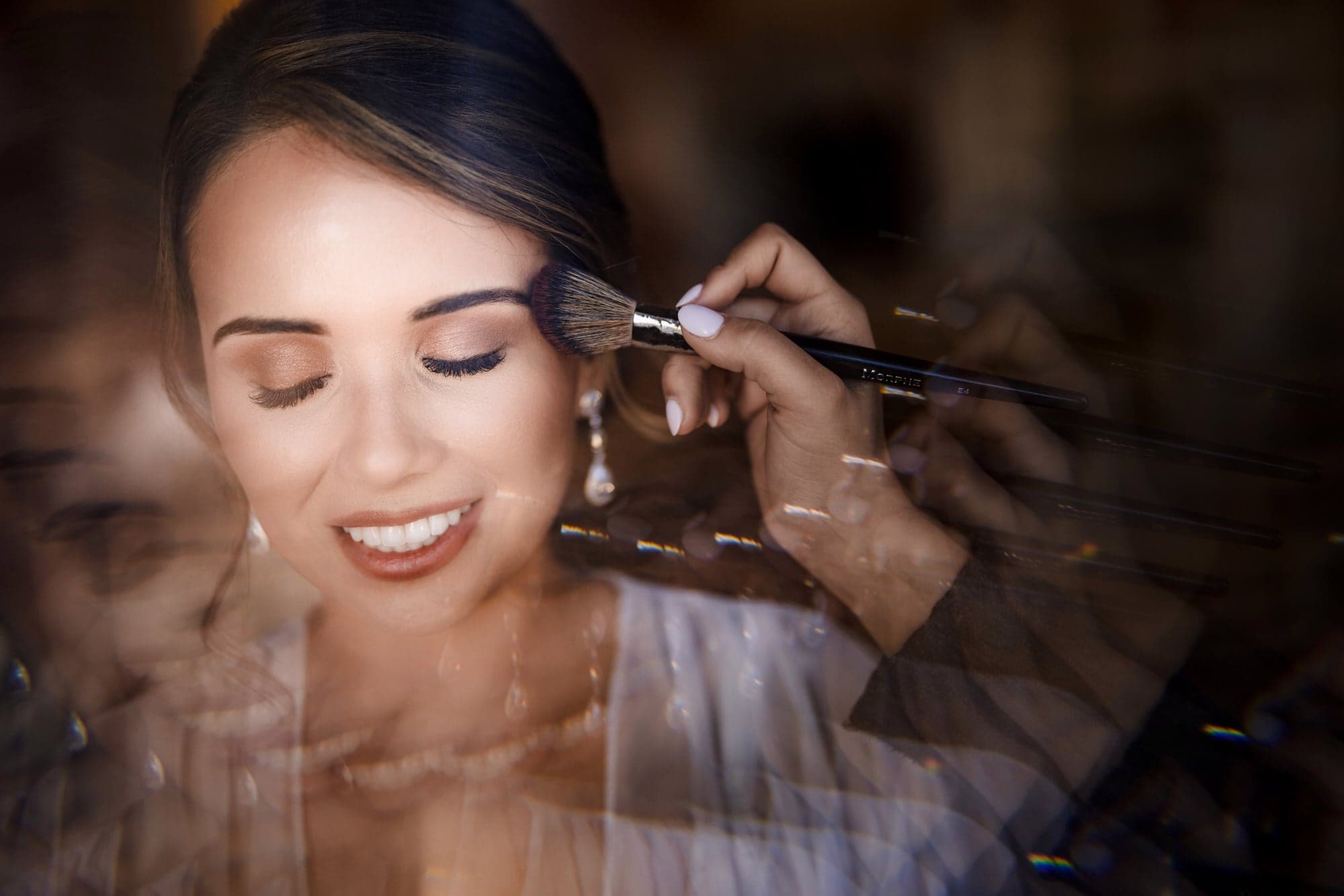 Ana having her makeup finished in soft window light at The Olana