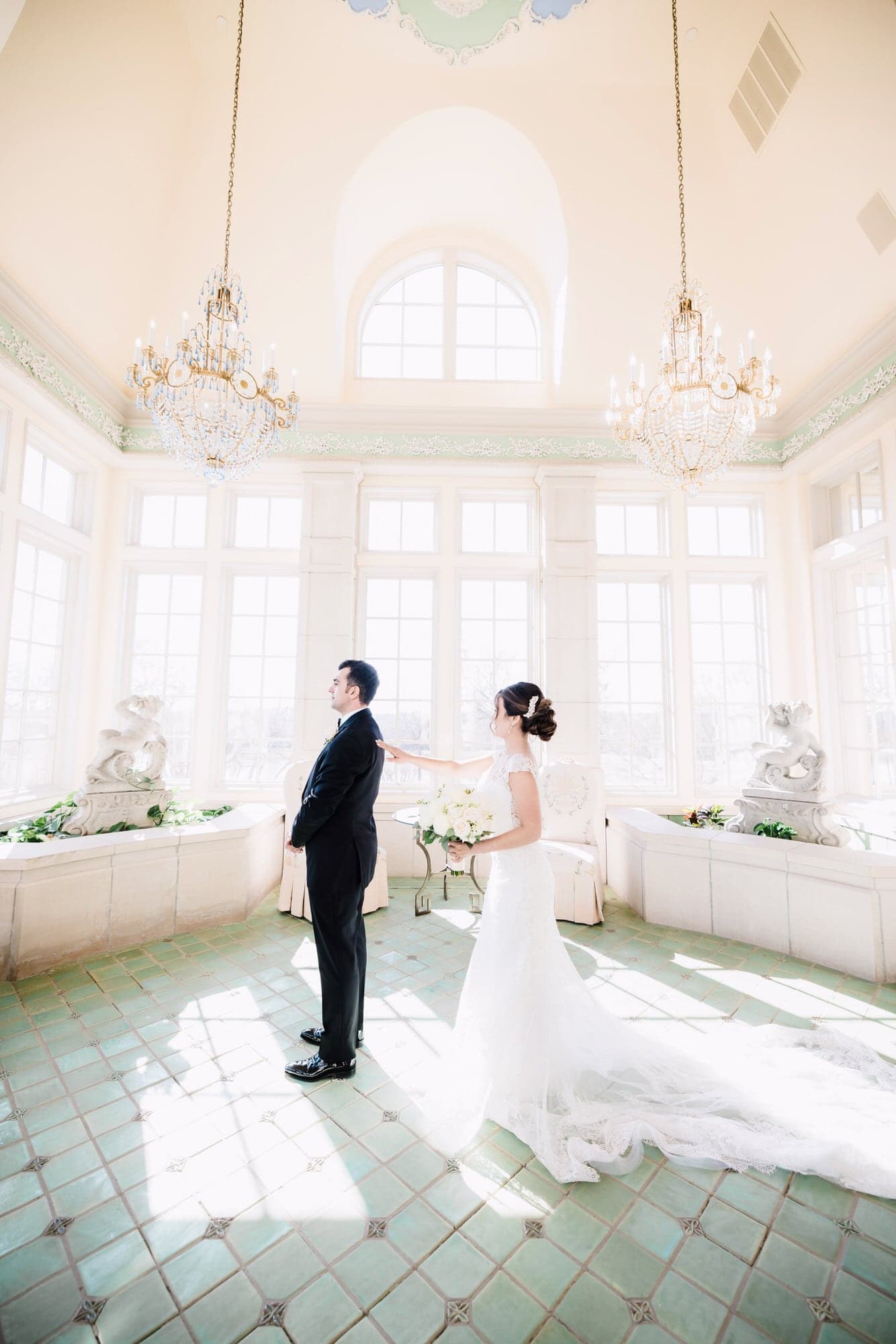 Ana walking through The Olana's bright marble hall toward Elio for their first look
