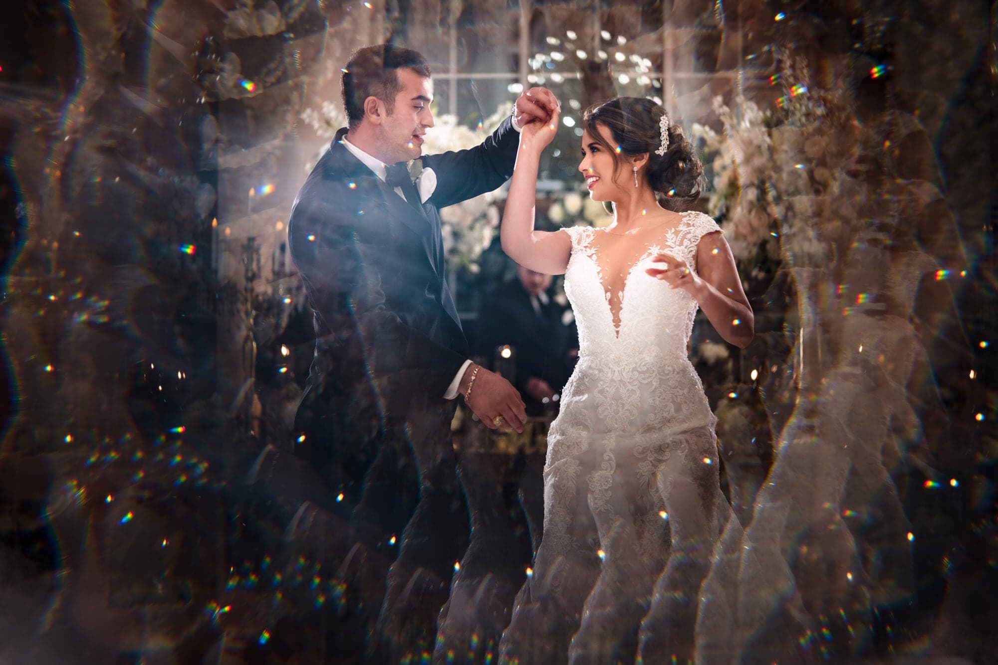 Ana and Elio celebrating together as sparks fill the reception at The Olana