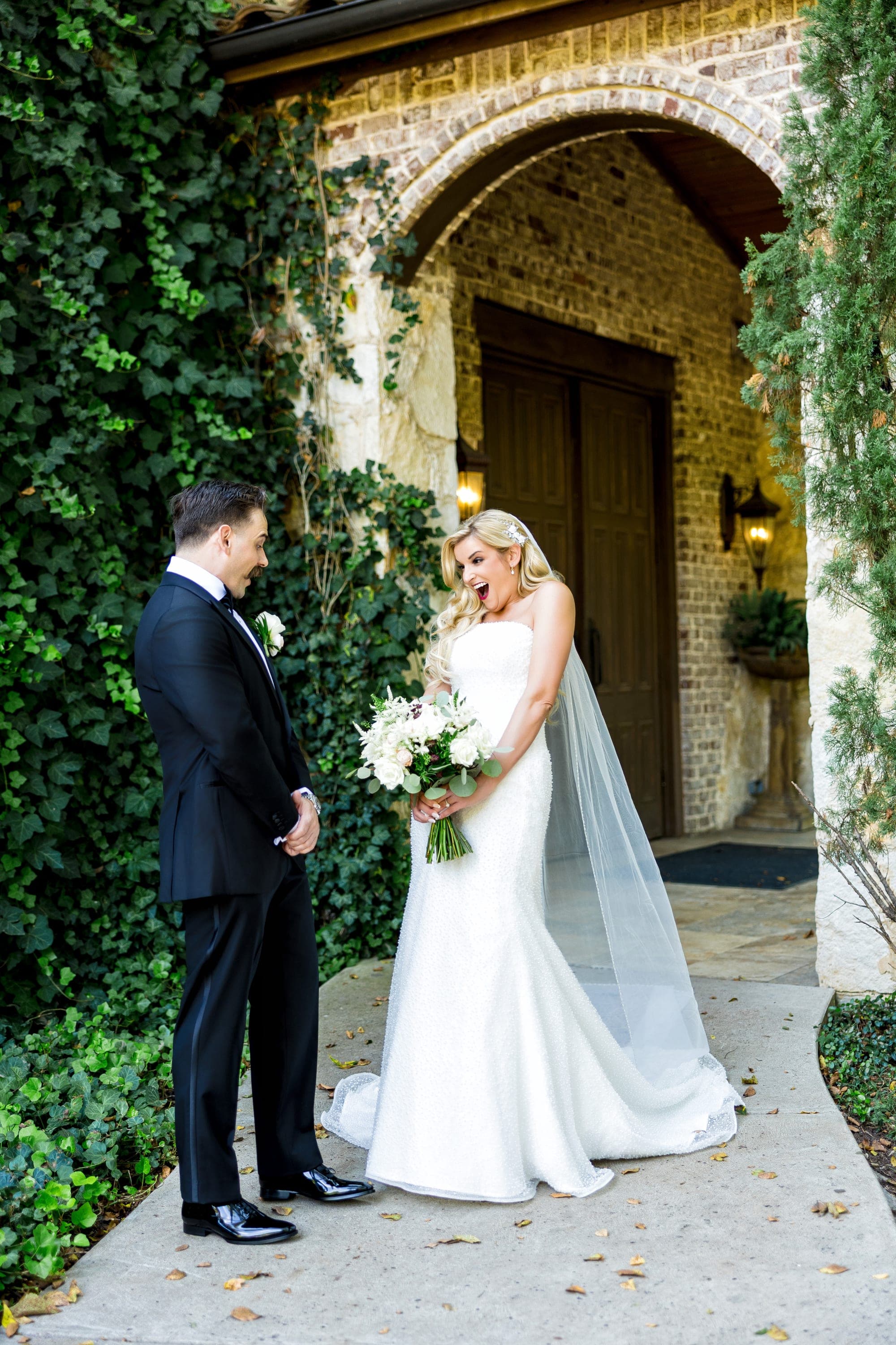 Beth and Austin's first look beneath the ivy-covered stone archway
