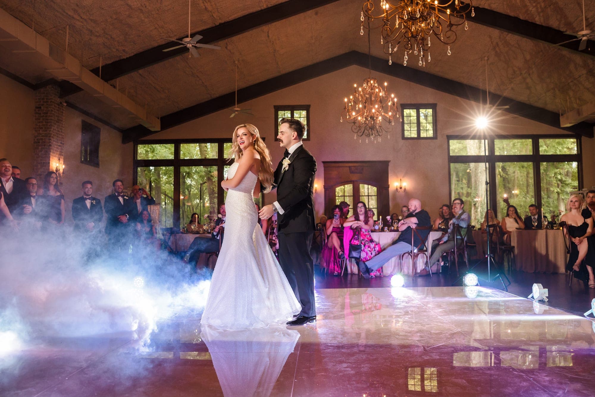 Beth and Austin's first dance on a low cloud of fog beneath the chandeliers