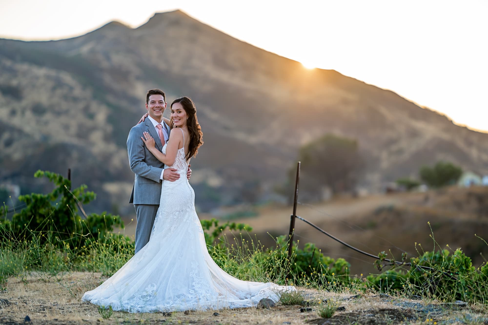 Allison and Joshua on the vineyard hillside as the sun sets behind the Santa Monica Mountains ridge