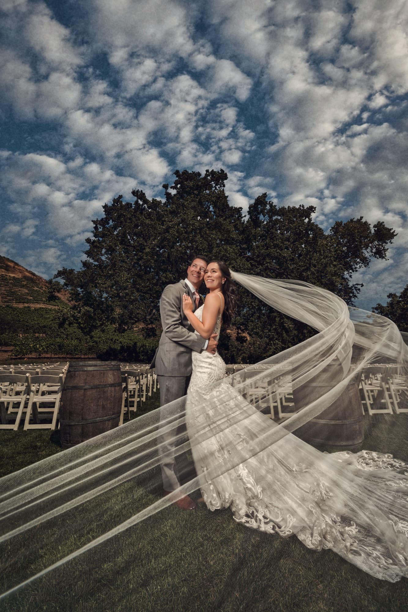 Allison's cathedral veil flying beneath the great oak under a dramatic dappled sky at Triunfo Creek Vineyards