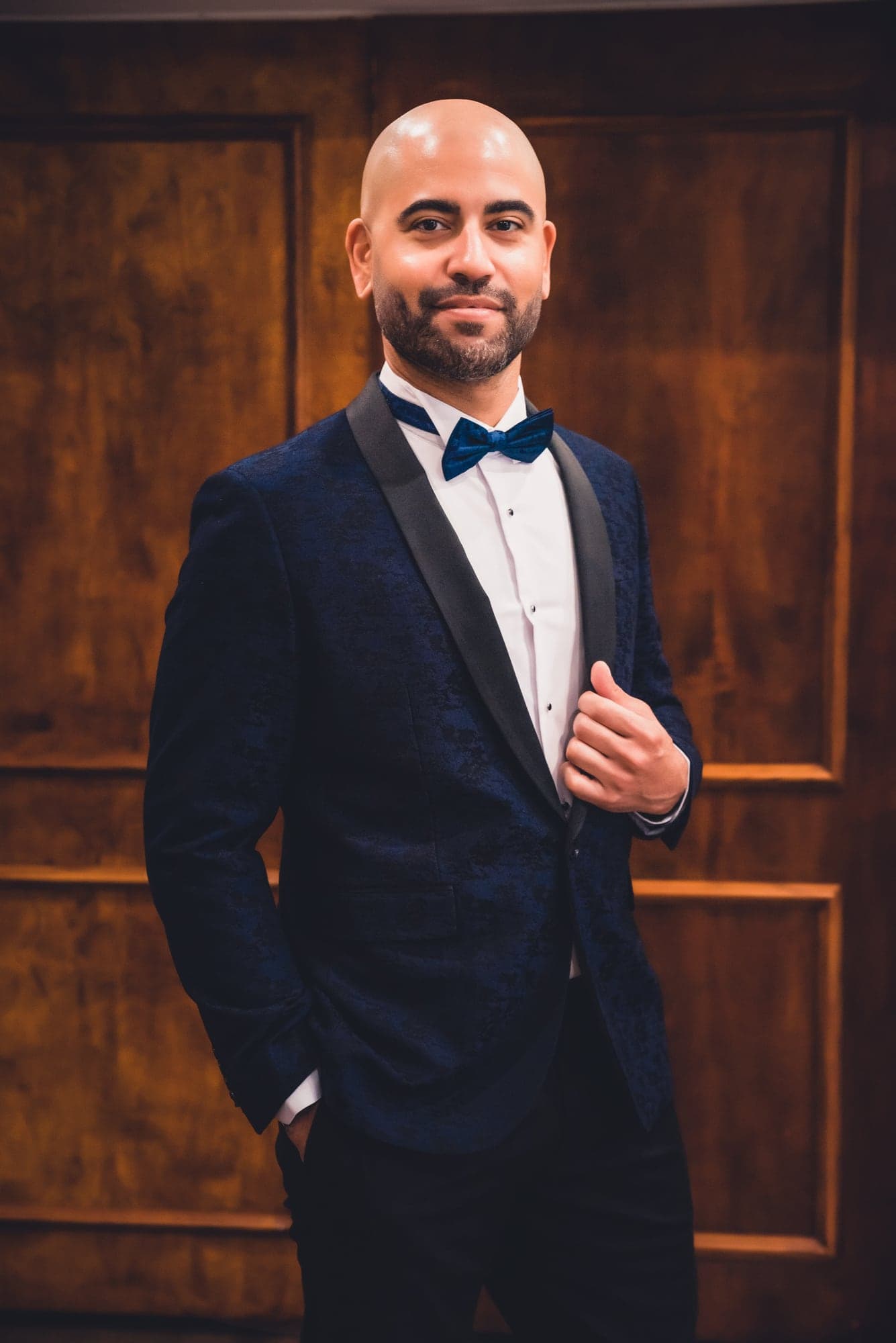 Aaron in a navy tuxedo