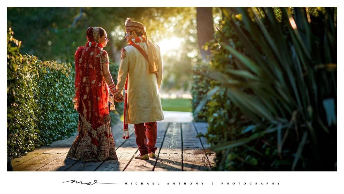 The newlyweds walking through golden light