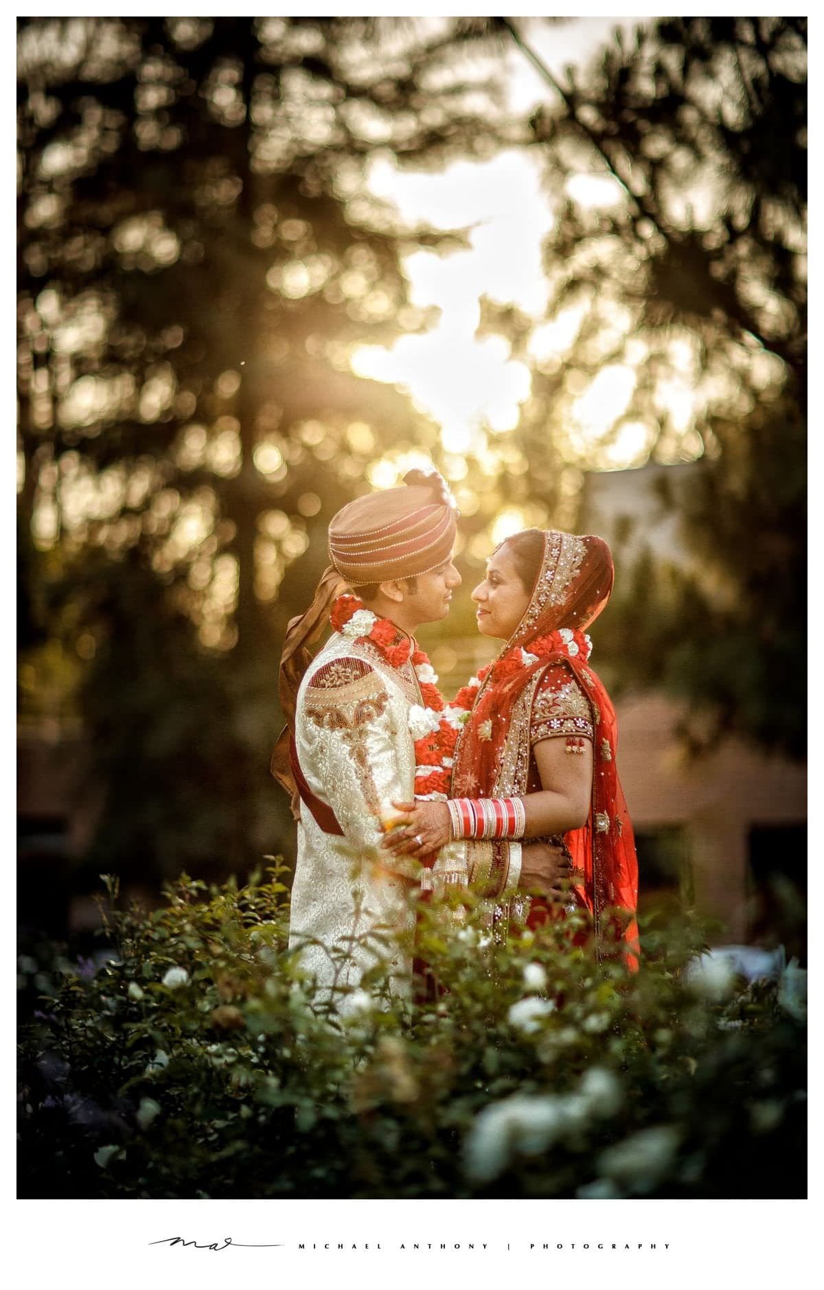 Aneet and Rishi together in golden light after their Indian wedding ceremony