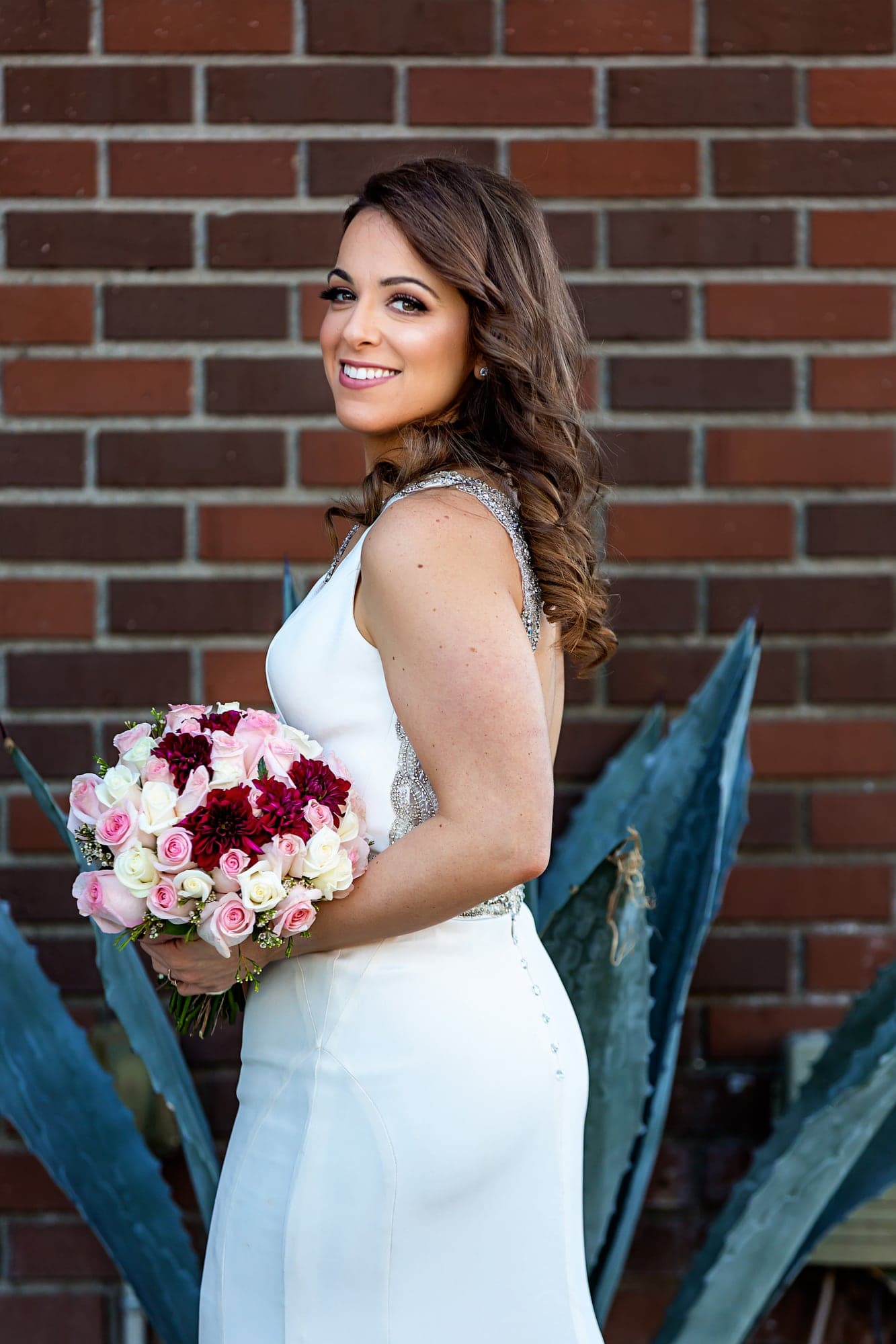 Bride photographed against the Vertigo brick exterior