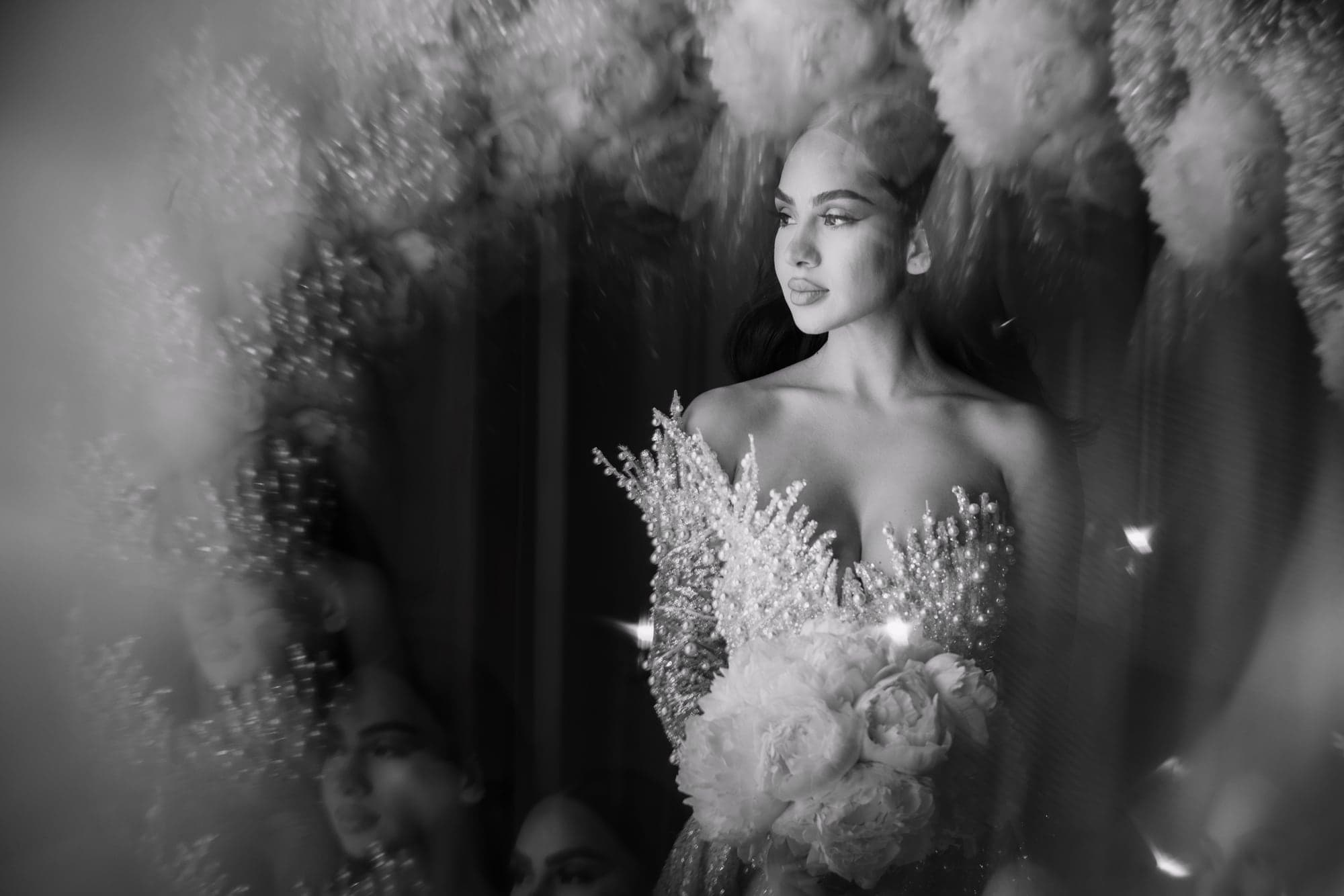 Afrika in her feathered wedding gown during a dramatic bridal portrait at Vibiana