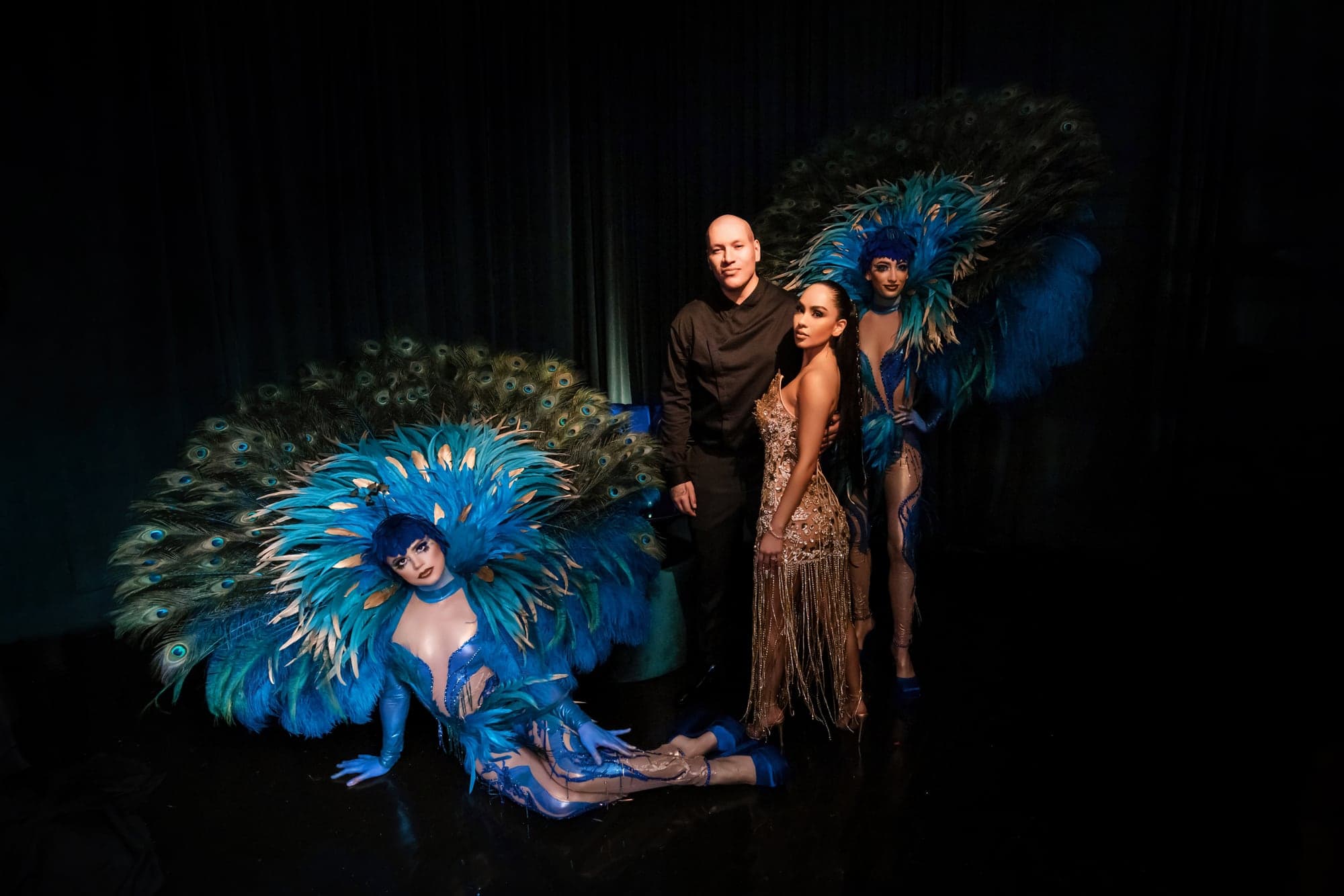 Afrika celebrating beneath a dramatic peacock fan during the Vibiana reception