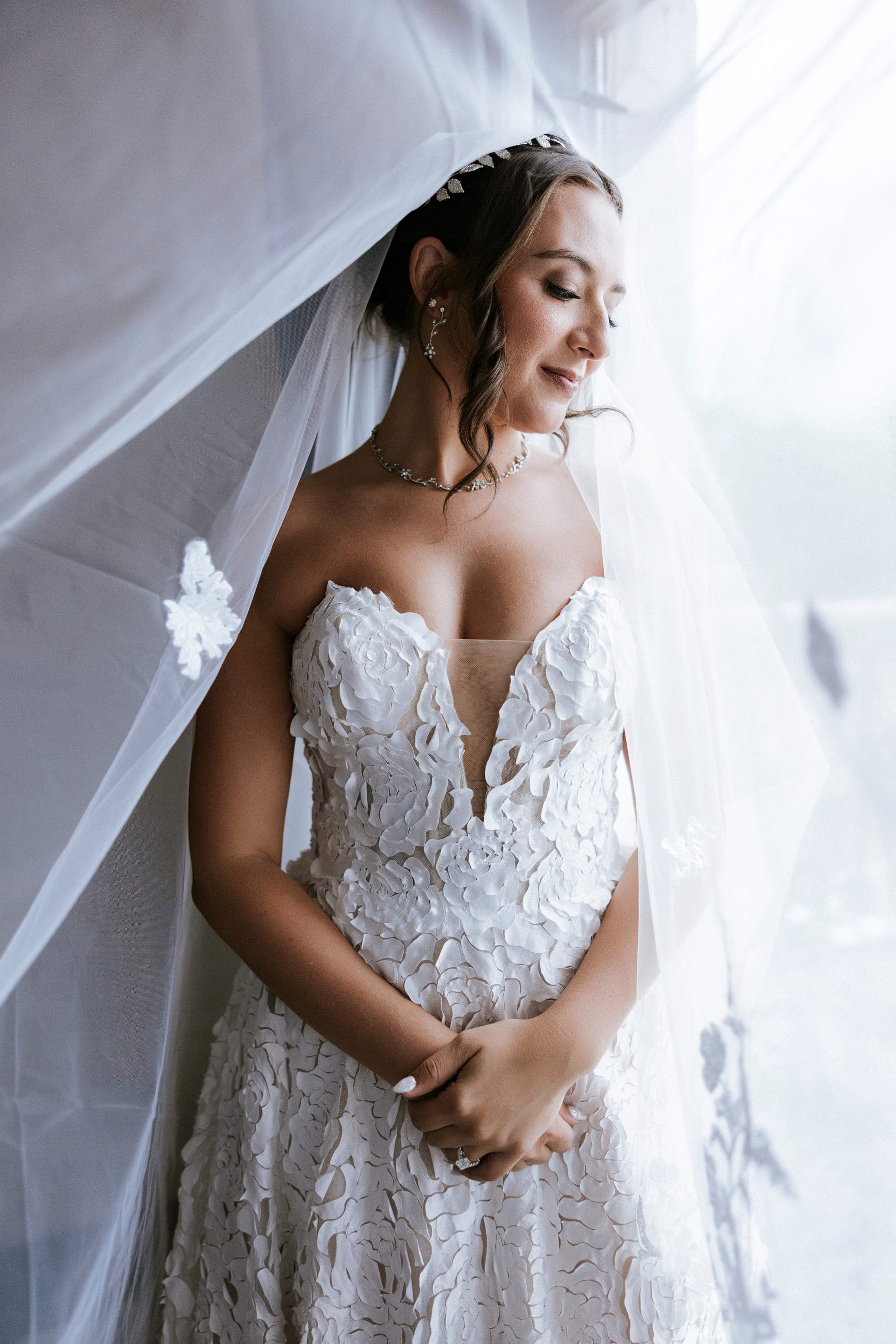 Kelsey beneath her cathedral veil in the window light