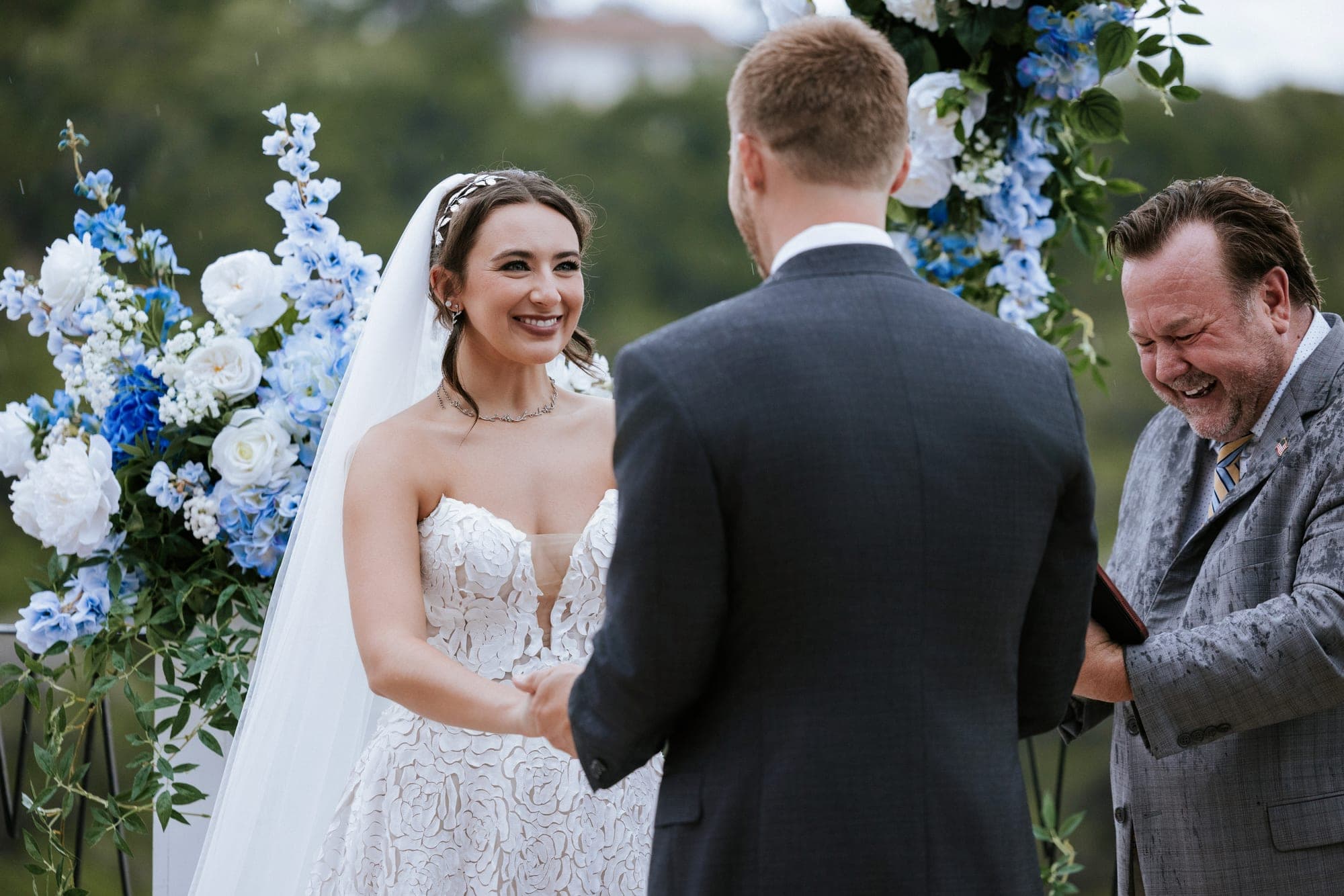 The ring exchange, the officiant laughing through the rain