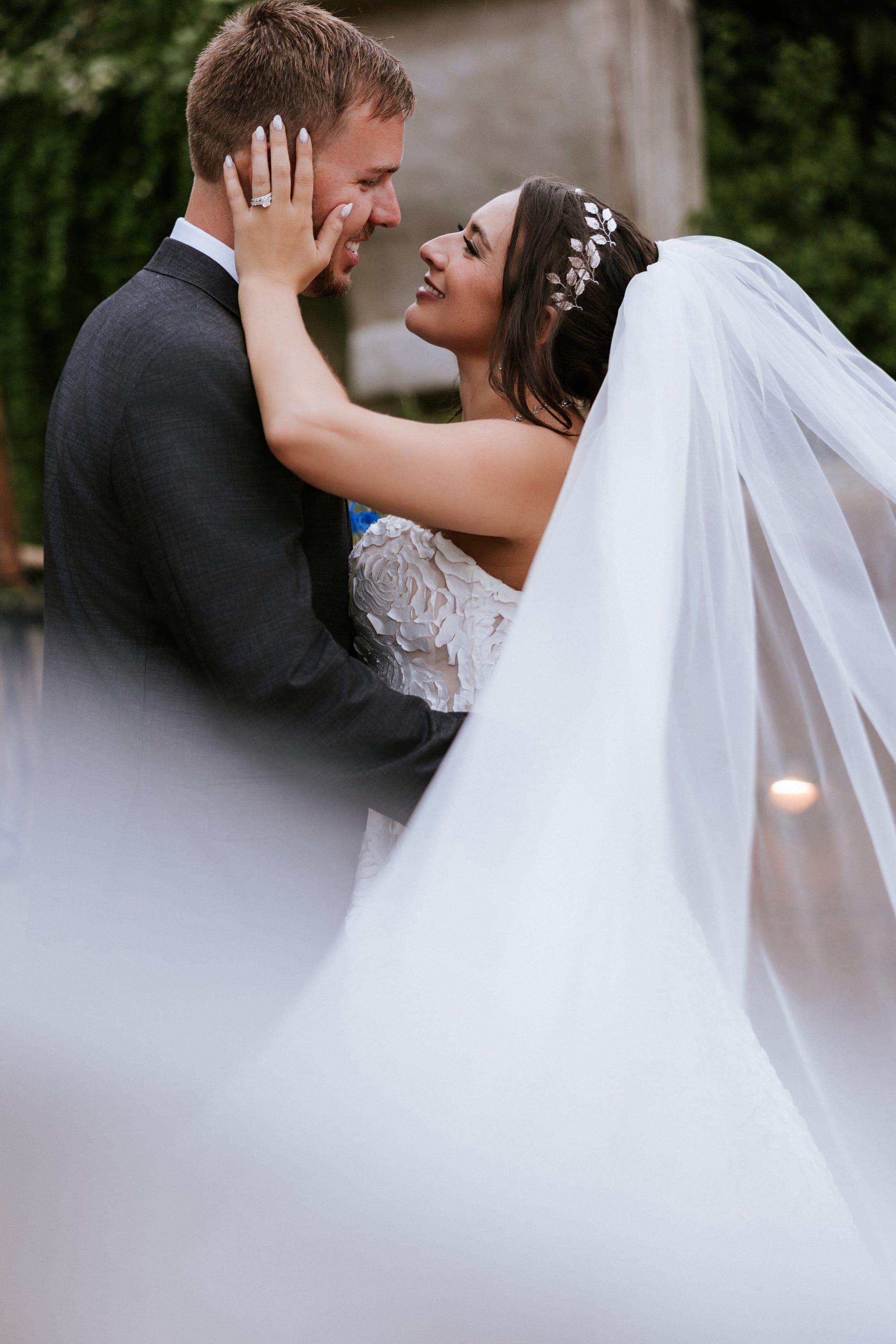 Kelsey's hand on Eric's cheek beneath the garden gazebo, her ring catching the light