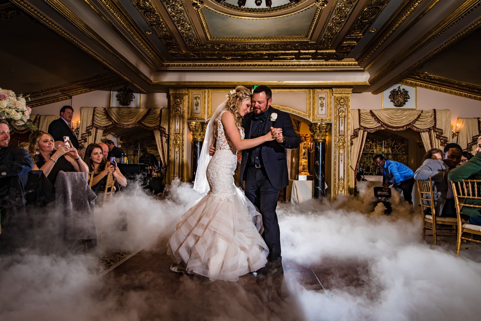 Amanda and Sean's first dance on a floor of rolling fog beneath the gold ceiling of the Trump National ballroom