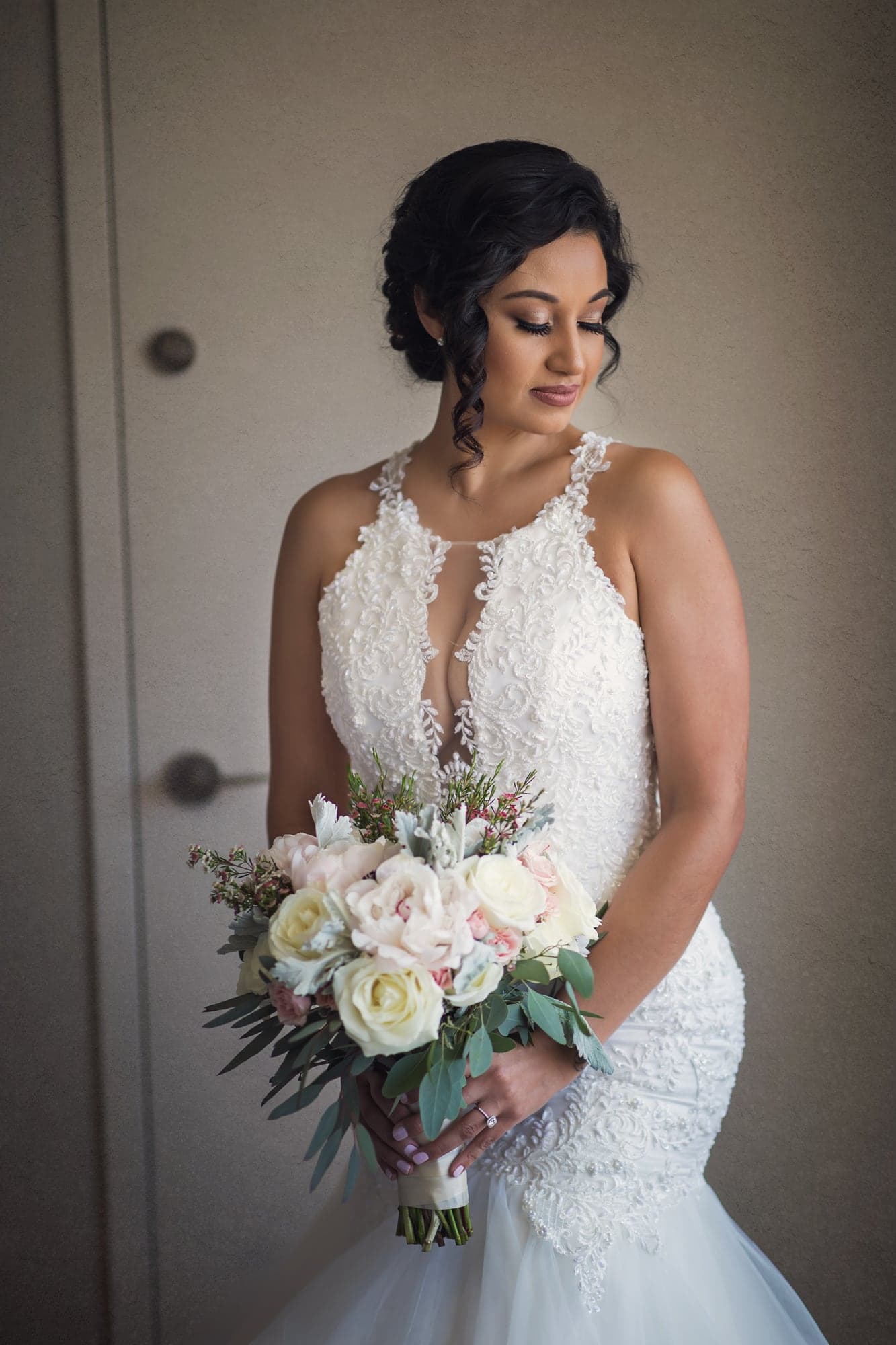 Bride holding a blush and white bouquet