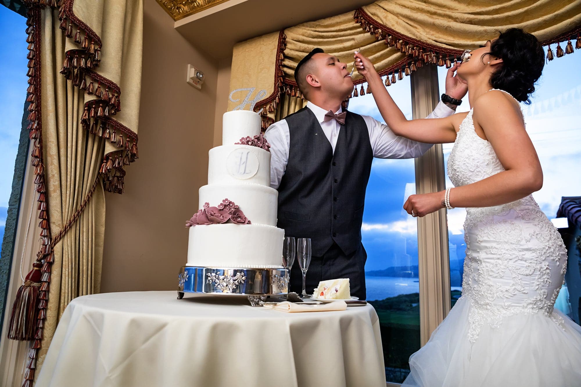 Bride and groom cutting their wedding cake