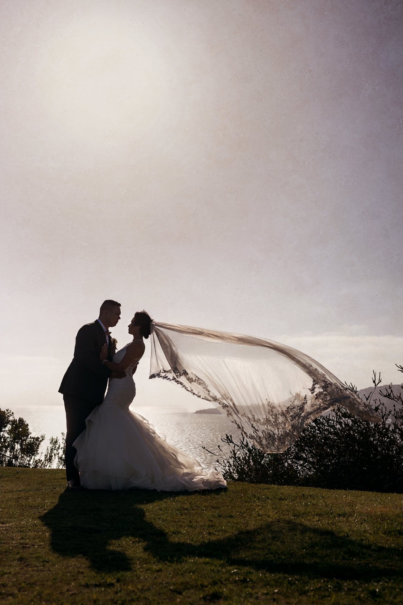Wedding couple silhouetted against a dramatic Palos Verdes sky