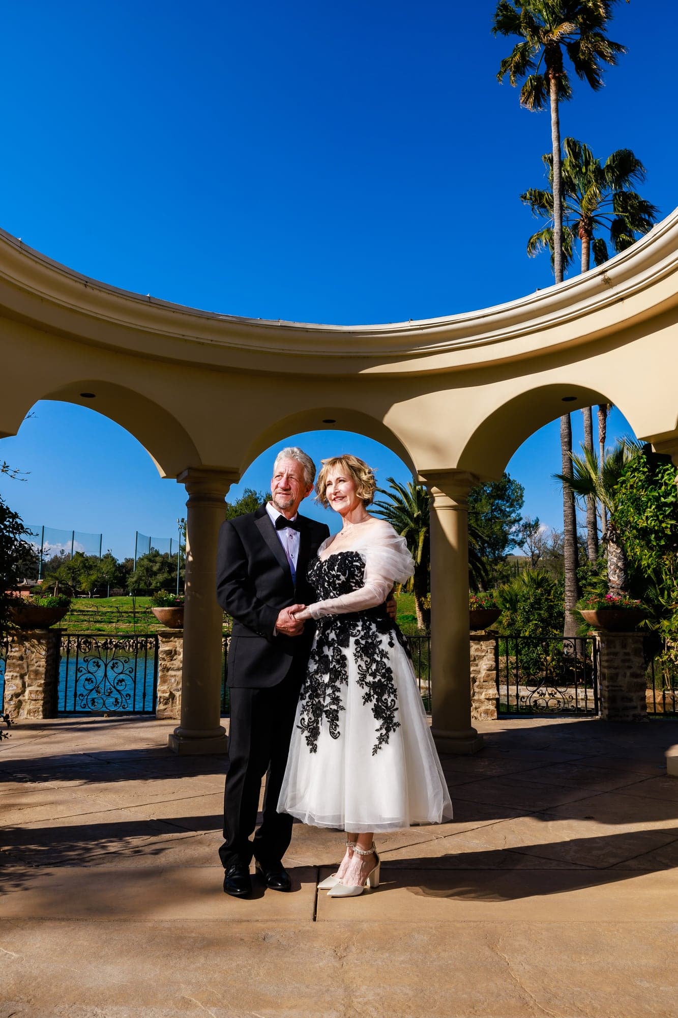 Donna and Greg beneath the stone arches at Westlake Village Inn