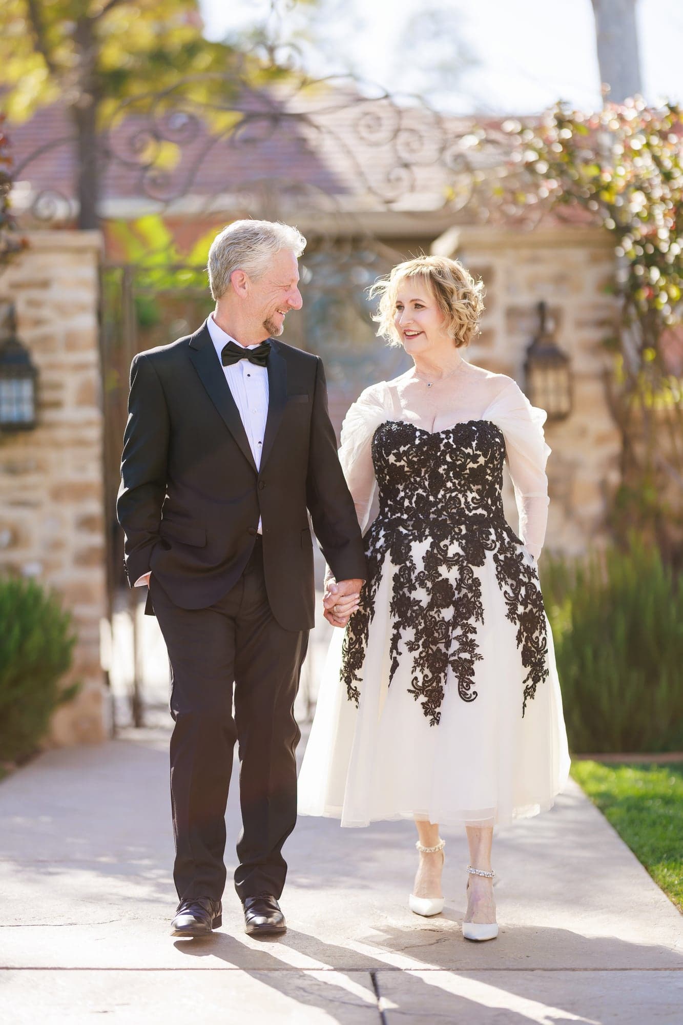 Donna and Greg walking together through the venue gardens