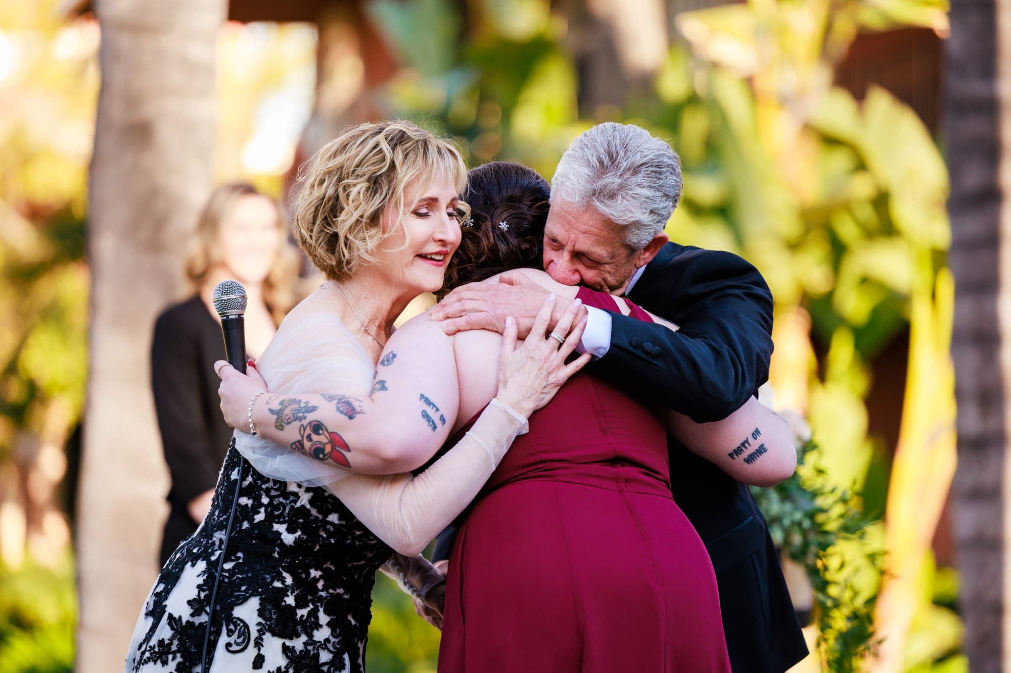 Greg embracing a family member during the wedding celebration
