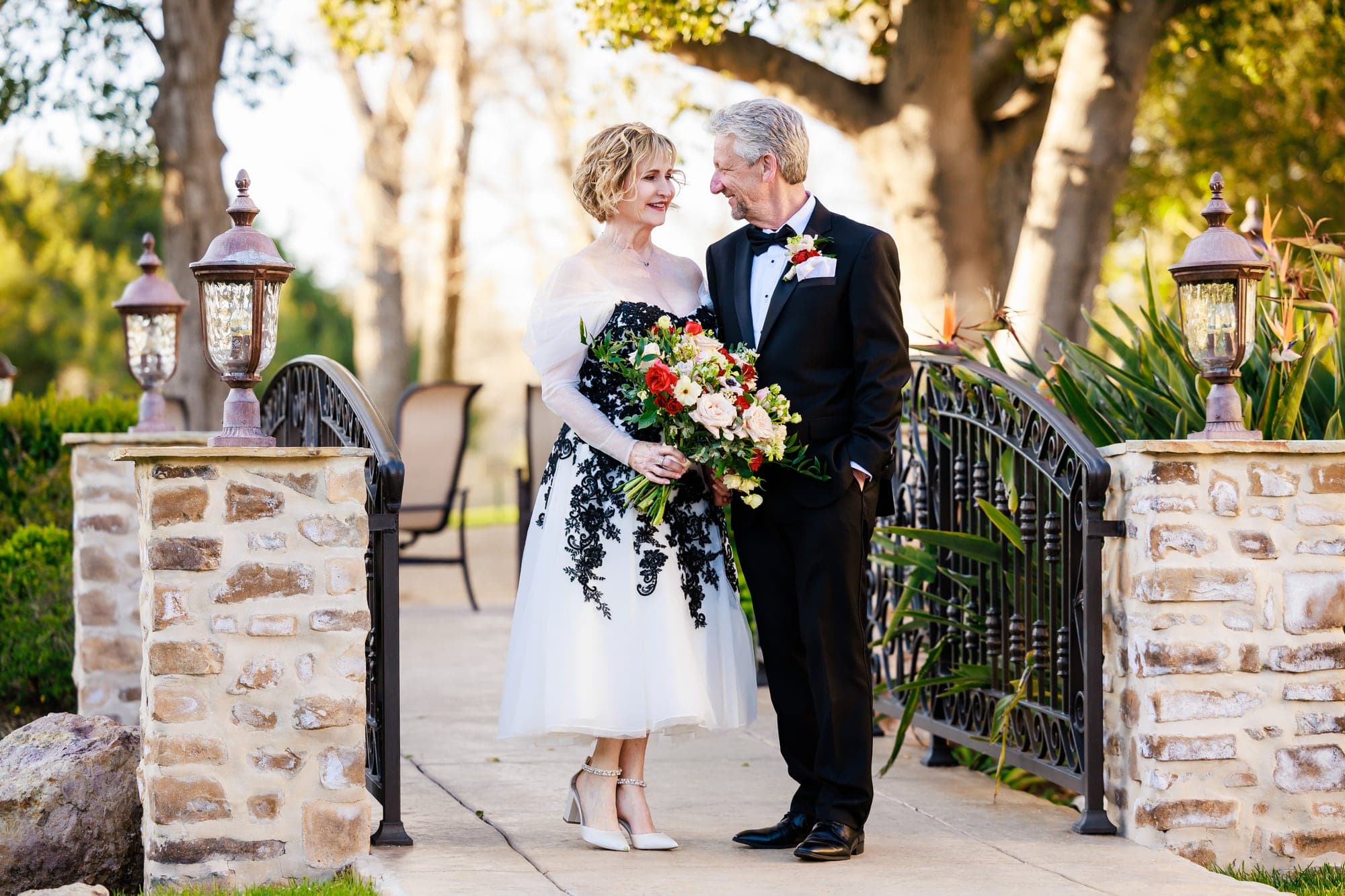 Donna and Greg beside a stone garden entrance