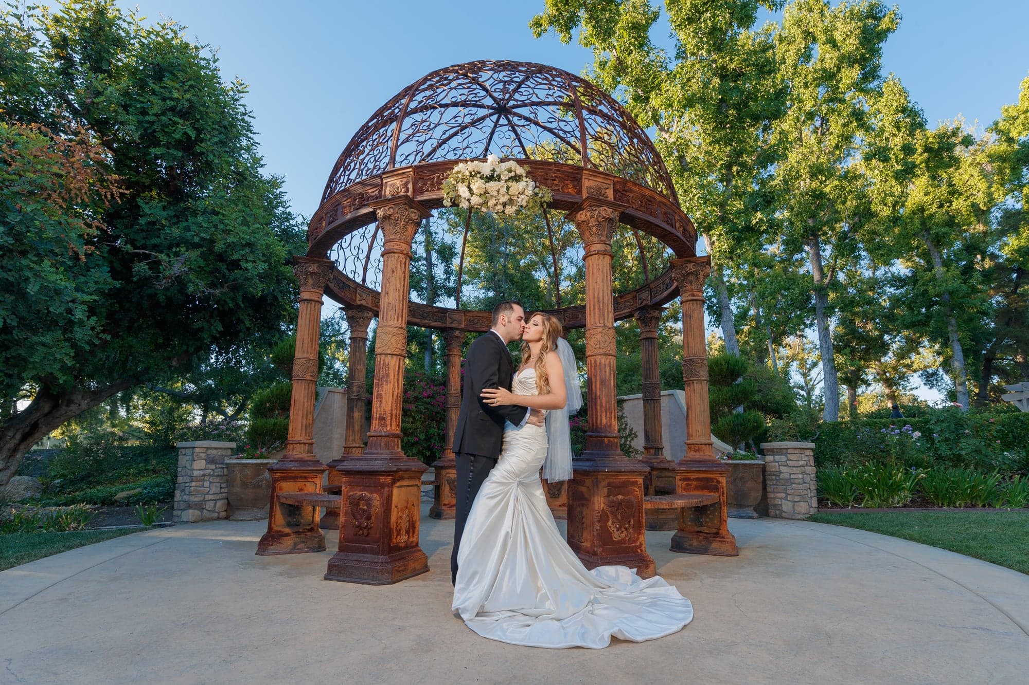 The Melanson newlyweds beneath the ornate garden gazebo at Westlake Village Inn