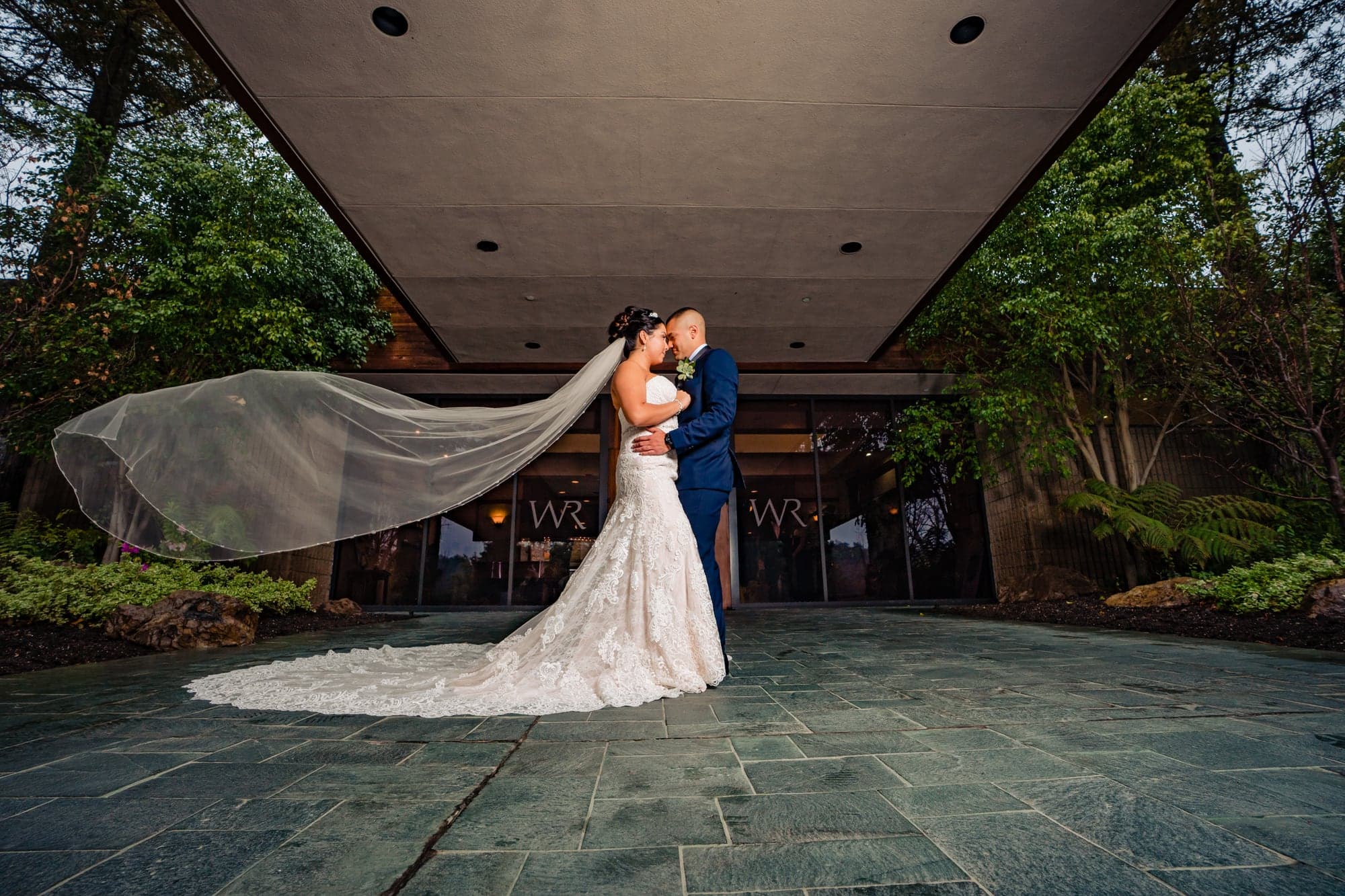 Bea and her partner beneath a flowing veil at Wood Ranch Country Club