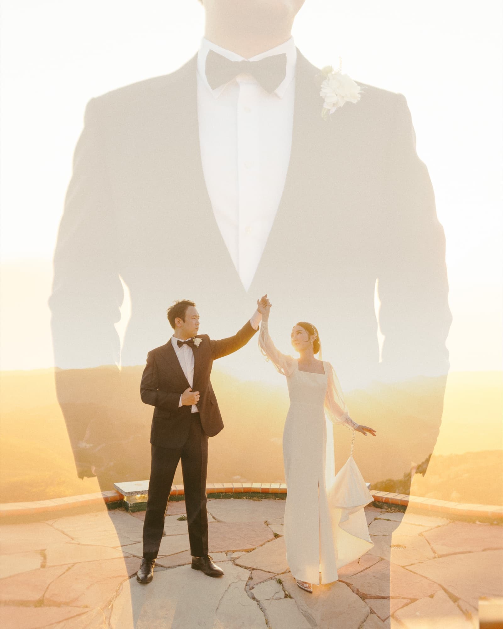 Artistic double exposure made with the Canon EOS R3, a groom's tuxedo silhouette layered over the couple raising joined hands on a mountaintop terrace at golden hour