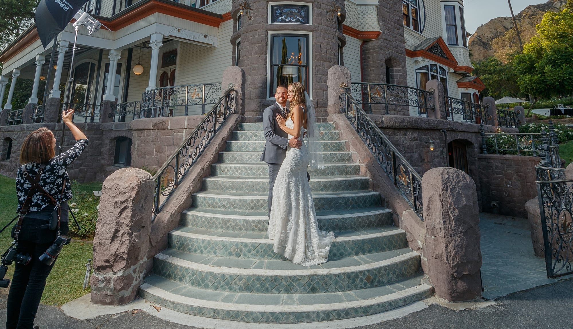 Wedding couple on the grand staircase of Newhall Mansion in Piru